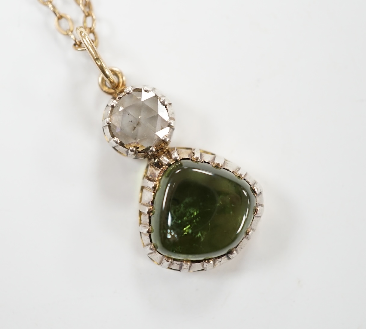 A Georgian yellow and white metal, rose cut diamond and shaped cabochon green tourmaline set pendant, 24mm, on a yellow metal chain, 48cm, gross weight 5.8 grams. Fair condition.